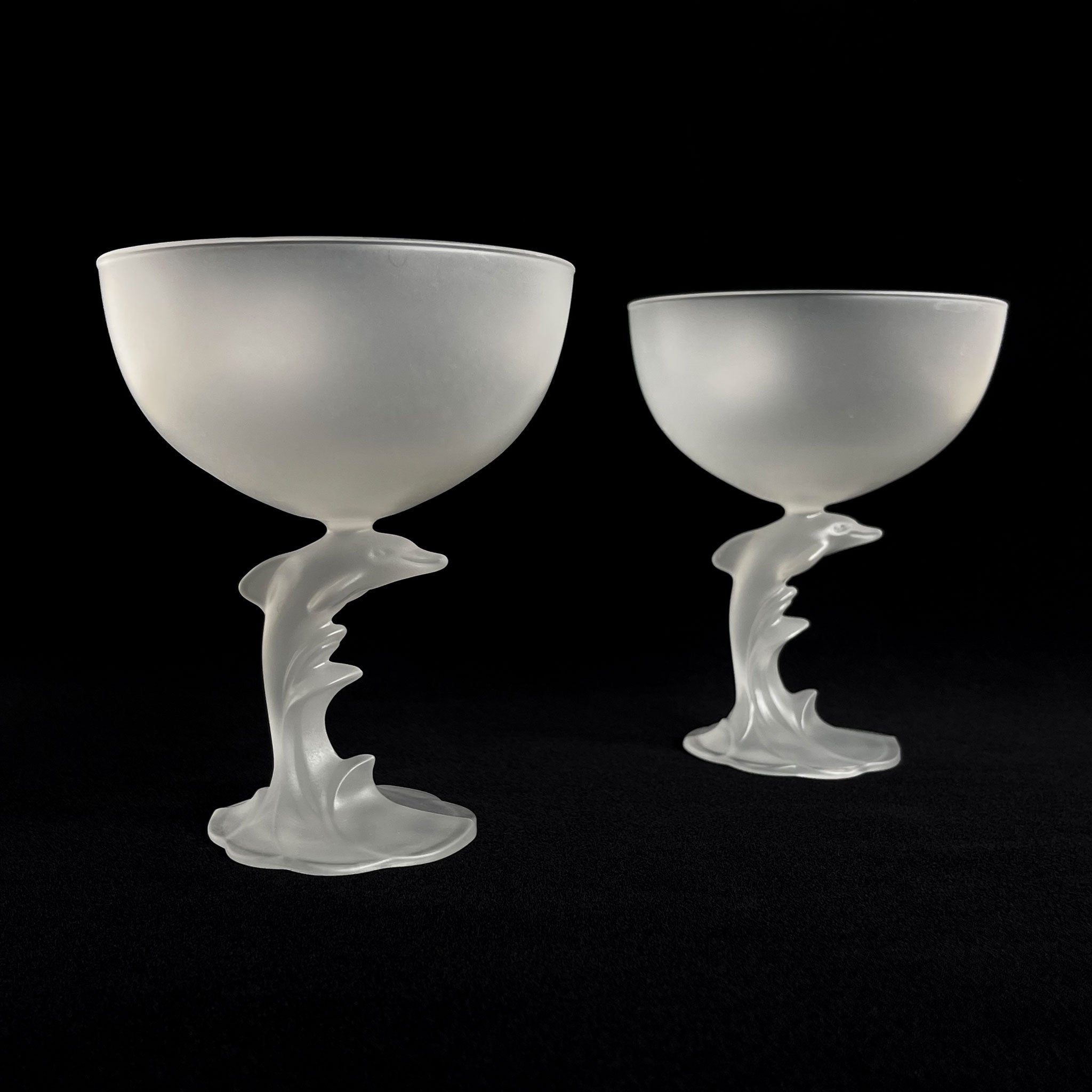 Set of 2 satin champagne glasses with sculptural dolphin-shaped stem, France, 1980s.
