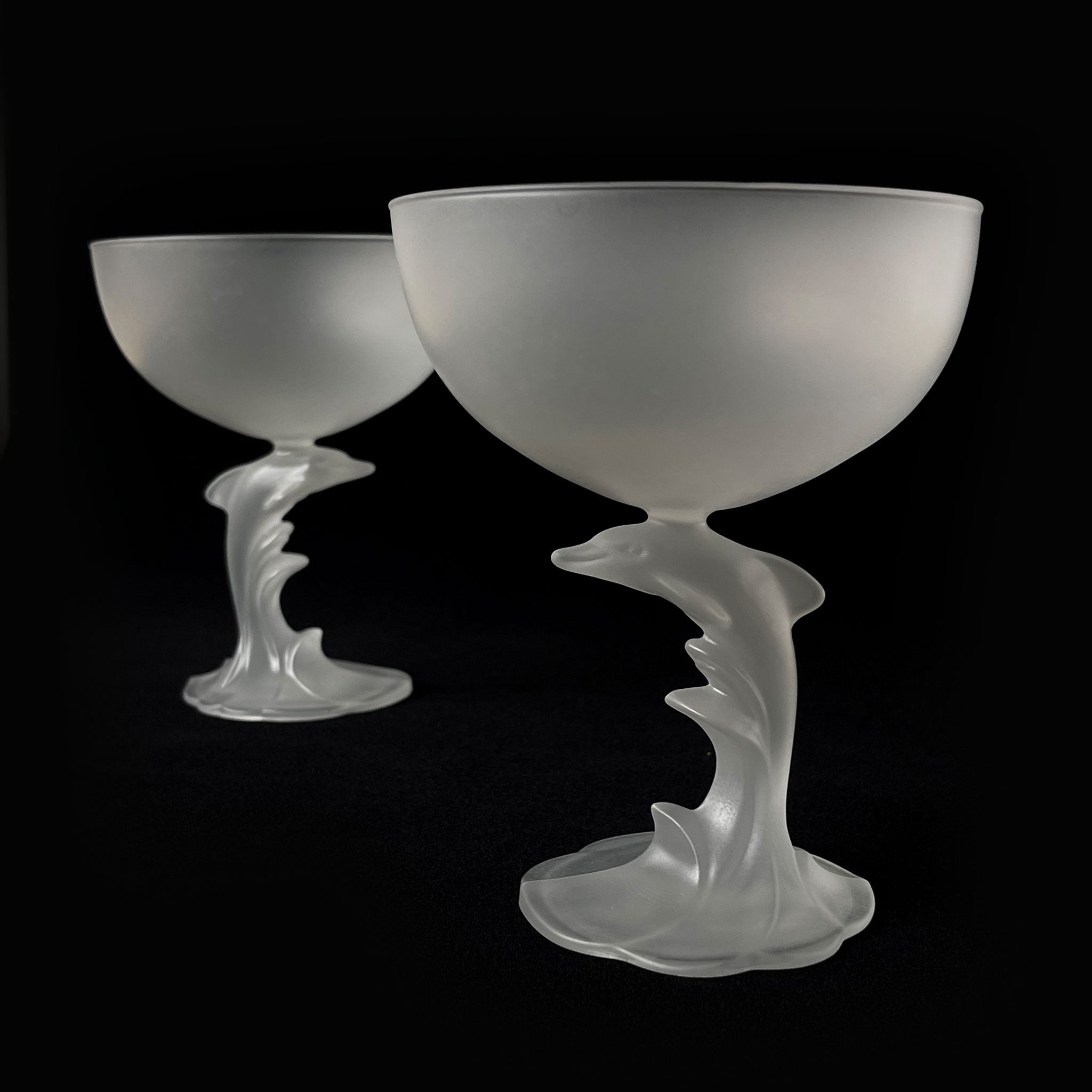 Set of 2 satin champagne glasses with sculptural dolphin-shaped stem, France, 1980s.