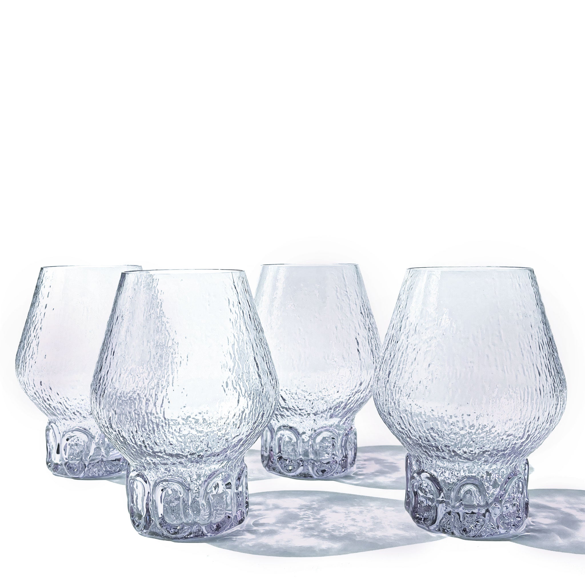 Organic Brutalist set of 4 balloon glasses in textured neodymium glass with hand-sculpted base, Italy, 1970s.