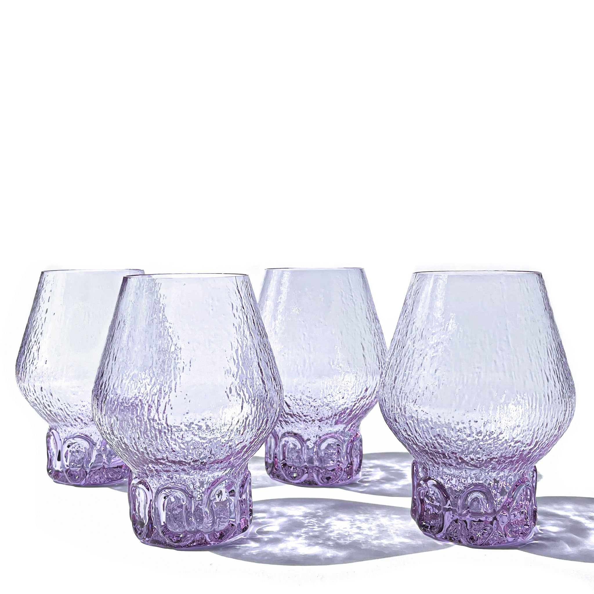 Organic Brutalist set of 4 balloon glasses in textured neodymium glass with hand-sculpted base, Italy, 1970s.